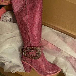 Pink rhinestone knee high boots.
